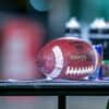 brown and blue football ball on black metal rack
