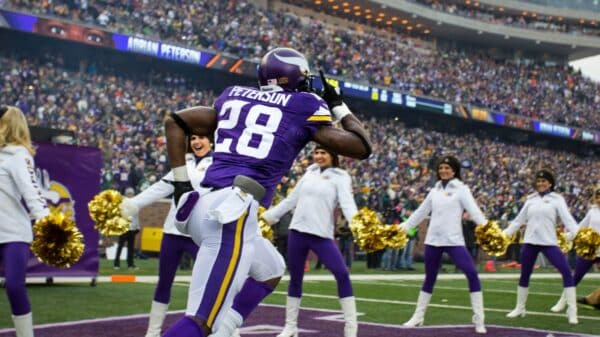 purple and white Peterson 28 running on stadium