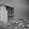 a black and white photo of a demolished building