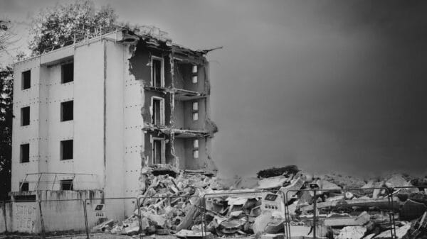 a black and white photo of a demolished building
