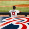 man in white jersey shirt playing baseball