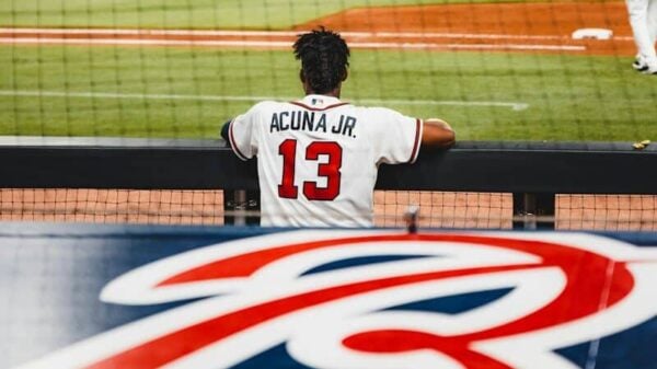 man in white jersey shirt playing baseball