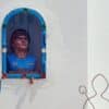 A bust of a man in a blue jersey inside a wall niche