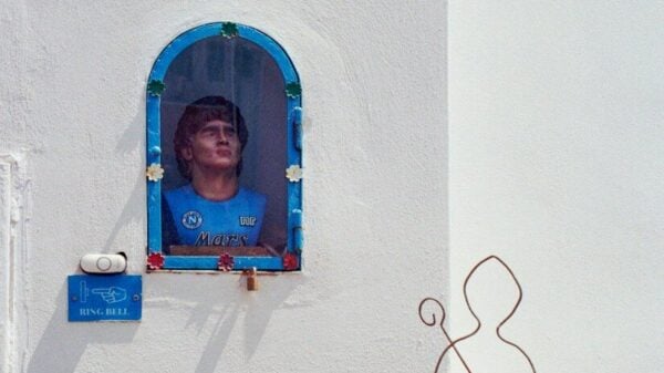 A bust of a man in a blue jersey inside a wall niche