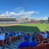people sitting on stadium chairs watching baseball game during daytime
