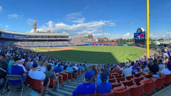 people sitting on stadium chairs watching baseball game during daytime